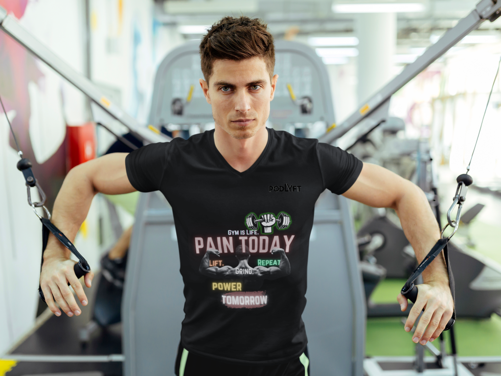 Gym Motivation T-Shirt | Pain Today, Power Tomorrow by PodLyft, featuring a motivational workout graphic, worn by a fit male model in a gym setting performing cable fly exercise. Perfect for fitness enthusiasts and gym lovers.