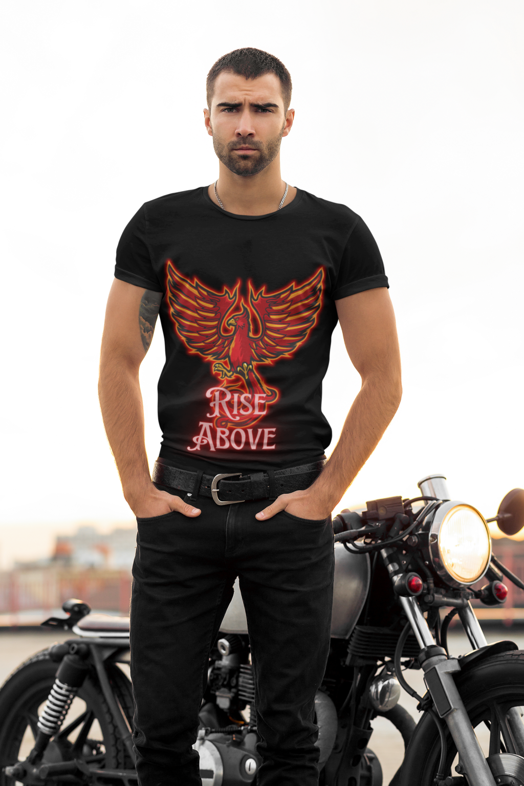 Rise Above T-Shirt - Phoenix Motivational Design by PodLyft, featuring a vibrant red and orange phoenix graphic on a black cotton T-shirt, worn by a confident model with a sleek urban backdrop.