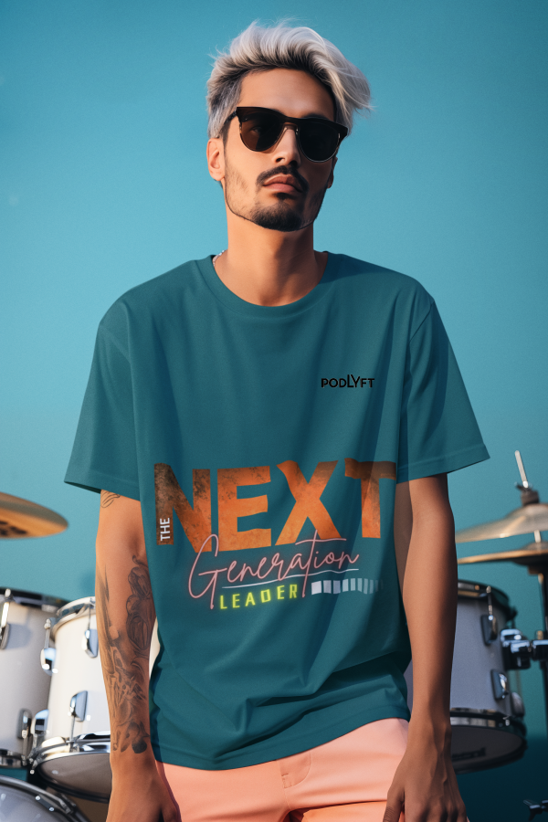A stylish young man wearing the Bold Next Generation Leader tee by PodLyft in petrol blue. The oversized t-shirt features a powerful leadership statement with 'NEXT' in textured orange, 'Generation' in elegant script, and 'LEADER' highlighted in a neon glow. The trendy design is complemented by a subtle abstract background, making it a bold fashion statement for visionaries and changemakers. The model, sporting sunglasses and a confident look, enhances the modern and empowering vibe of the tee.