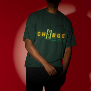 Small-size 'Change is Constant' Tee in Bottle Green – A motivational oversized tee featuring dynamic typography in yellow and green. Crafted from 240 GSM super-combed cotton, ensuring premium comfort and longevity.