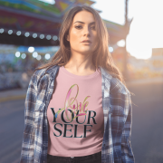 Comfortable baby pink cotton crop top with a bold "Love Yourself" statement, combining brushstroke artistry with a neon glow effect. Ideal for everyday wear and motivation.