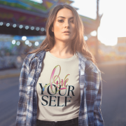 Chic beige crop top with an empowering "Love Yourself" message in a mix of artistic calligraphy and modern typography. Designed for comfort, confidence, and style.