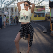 Stylish beige crop top featuring the "Love Yourself" design with a blend of vibrant brushstroke colors and neon typography. A perfect mix of elegance and motivation.