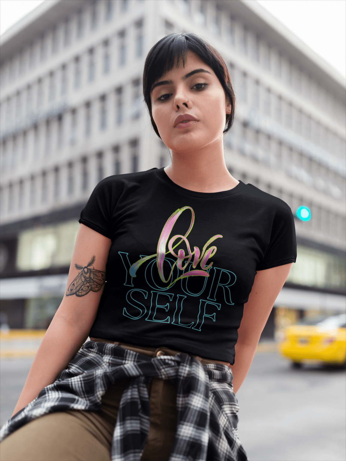 Stylish young woman wearing the Love Yourself crop top in black, featuring an elegant brushstroke and neon typography design. A trendy and empowering fashion statement for self-love and confidence.