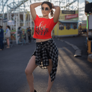 A stylish red crop top featuring the "Love Yourself" design in vibrant brushstroke lettering and sleek neon typography. Perfect for self-love and confidence.