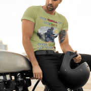 Medium-sized olive green Thrill Rider tee featuring a high-energy motorbike rider against a scenic outdoor backdrop. The bold typography and adventurous design make this an ideal tee for motorcycle lovers and thrill-seekers.