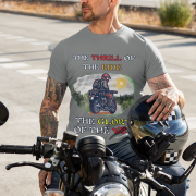 Steel grey Thrill Rider tee in large size, crafted for motorcycle enthusiasts who embrace freedom and adventure. The striking biker graphic and powerful typography capture the spirit of the open road.