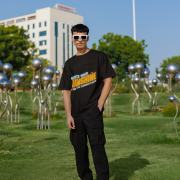 Black oversized T-shirt with a motivational 'CREATE YOUR SUNSHINE EVEN ON THE CLOUDIEST DAYS' design. Bright sky-blue, orange/yellow, and white text with a sun icon. DTG-printed on durable 240 GSM cotton fabric. Double Extra Large size.