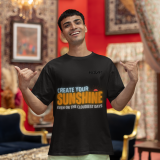 Motivational black oversized T-shirt with a bold 'CREATE YOUR SUNSHINE EVEN ON THE CLOUDIEST DAYS' design. Vibrant sky-blue, orange/yellow, and white text with a sun icon. DTG-printed on durable 240 GSM cotton fabric. Small size.