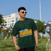 Stylish bottle green oversized T-shirt with a motivational quote 'CREATE YOUR SUNSHINE EVEN ON THE CLOUDIEST DAYS.' Contrasting sky-blue, orange/yellow, and white text with a sun icon. DTG-printed on premium 240 GSM cotton fabric. Large size.