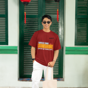 Maroon oversized tee with a bright and uplifting 'CREATE YOUR SUNSHINE EVEN ON THE CLOUDIEST DAYS' design. Features sky-blue, orange/yellow, and white text with a sun icon. DTG-printed on soft 240 GSM cotton fabric. Medium size.