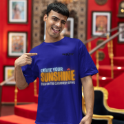 Comfortable navy blue oversized T-shirt with an inspiring 'CREATE YOUR SUNSHINE EVEN ON THE CLOUDIEST DAYS' design. Includes vibrant sky-blue, orange/yellow, and white text with a sun icon. DTG-printed on high-quality 240 GSM cotton. Extra Large size.