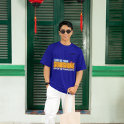 Navy blue oversized tee with a bright and uplifting 'CREATE YOUR SUNSHINE EVEN ON THE CLOUDIEST DAYS' design. Features sky-blue, orange/yellow, and white text with a sun icon. DTG-printed on soft 240 GSM cotton fabric. Medium size.