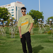 Olive green oversized T-shirt with a motivational 'CREATE YOUR SUNSHINE EVEN ON THE CLOUDIEST DAYS' design. Bright sky-blue, orange/yellow, and white text with a sun icon. DTG-printed on durable 240 GSM cotton fabric. Double Extra Large size.