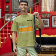 Olive green oversized T-shirt featuring a motivational design with 'CREATE YOUR SUNSHINE EVEN ON THE CLOUDIEST DAYS' in sky-blue, warm orange/yellow, and white text. Includes a sun icon, printed using DTG on premium 240 GSM cotton fabric. Extra Small size.