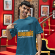 Comfortable petrol blue oversized T-shirt with an inspiring 'CREATE YOUR SUNSHINE EVEN ON THE CLOUDIEST DAYS' design. Includes vibrant sky-blue, orange/yellow, and white text with a sun icon. DTG-printed on high-quality 240 GSM cotton. Extra Large size.