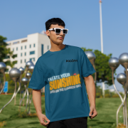 Stylish petrol blue oversized T-shirt with a motivational quote 'CREATE YOUR SUNSHINE EVEN ON THE CLOUDIEST DAYS.' Contrasting sky-blue, orange/yellow, and white text with a sun icon. DTG-printed on premium 240 GSM cotton fabric. Large size.