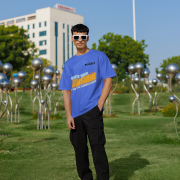 Royal blue oversized T-shirt with a motivational 'CREATE YOUR SUNSHINE EVEN ON THE CLOUDIEST DAYS' design. Vibrant sky-blue, orange/yellow, and white text with a sun icon. DTG-printed on high-quality 240 GSM cotton fabric. Double Extra Large size.