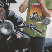 Olive green Road Warrior tee in small size, designed for bikers who embrace the open road. The striking motorcyclist silhouette, bold typography, and adventurous sunset backdrop create a powerful and stylish biker statement.