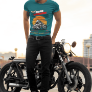 Medium-sized petrol blue Road Warrior tee featuring a dynamic motorcyclist riding through the open road against a vibrant sunset. The bold "ROAD WARRIOR" typography and motivational message symbolize resilience, freedom, and a fearless mindset.