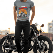 Medium-sized steel grey Road Warrior tee with a powerful design showcasing a motorcyclist in motion against a vibrant sunset. The bold "ROAD WARRIOR" text and motivational phrase add to the rebellious and adventurous biker aesthetic.