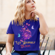 Model in a deep navy blue 'Bloom Yourself' T-shirt, adorned with a bold floral and butterfly design. A powerful and chic fashion statement, available at PodLyft.