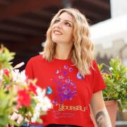 Woman styled in a striking red 'Bloom Yourself' T-shirt, featuring an intricate floral and butterfly design. A vibrant and confident look, available at PodLyft.