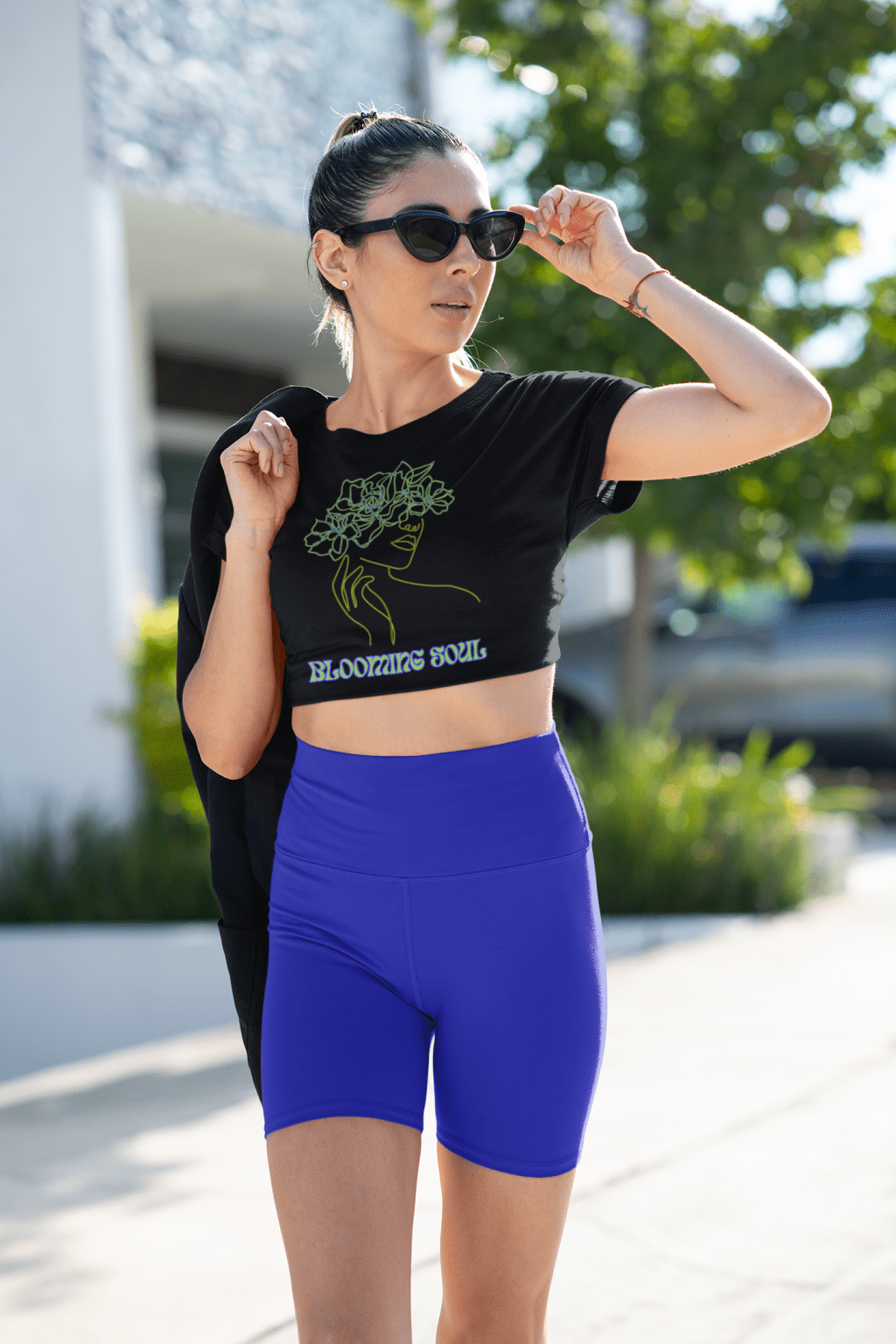 Confident and stylish, a woman wears the Blooming Soul Tee in black, featuring an elegant floral line art design. This chic and modern tee from PodLyft blends fashion with artistic expression, perfect for a bold yet feminine look.
