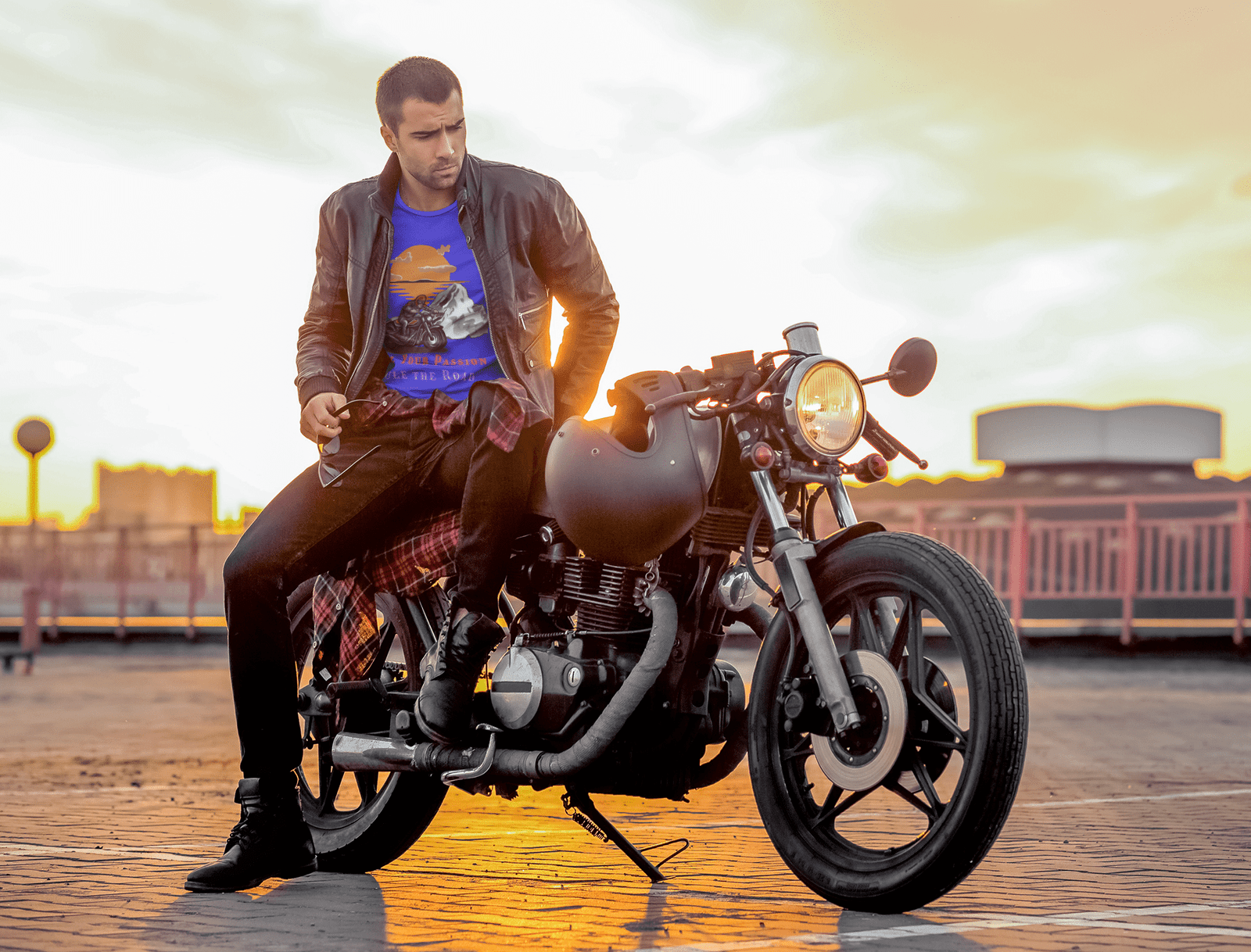 A man on a motorcycle, wearing a bold graphic tee, representing the thrill of adventure and the biker lifestyle.  