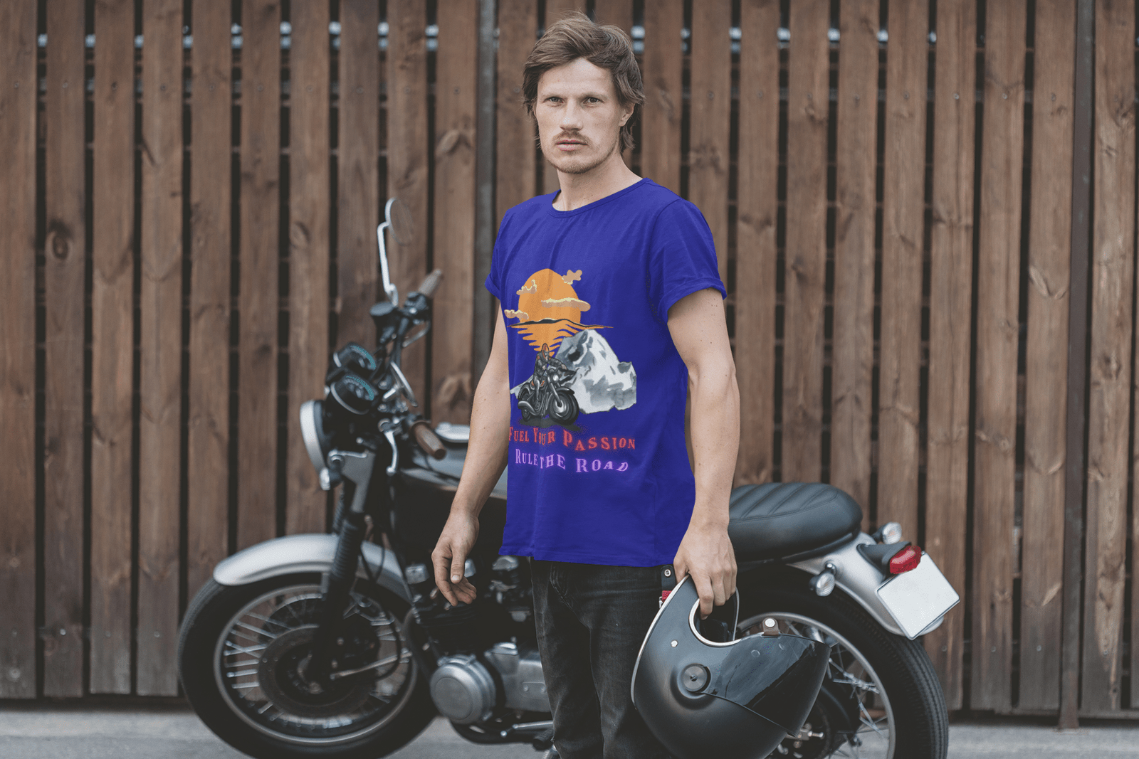 A man stands beside a motorcycle, showcasing a bold biker graphic tee that embodies adventure and freedom.  