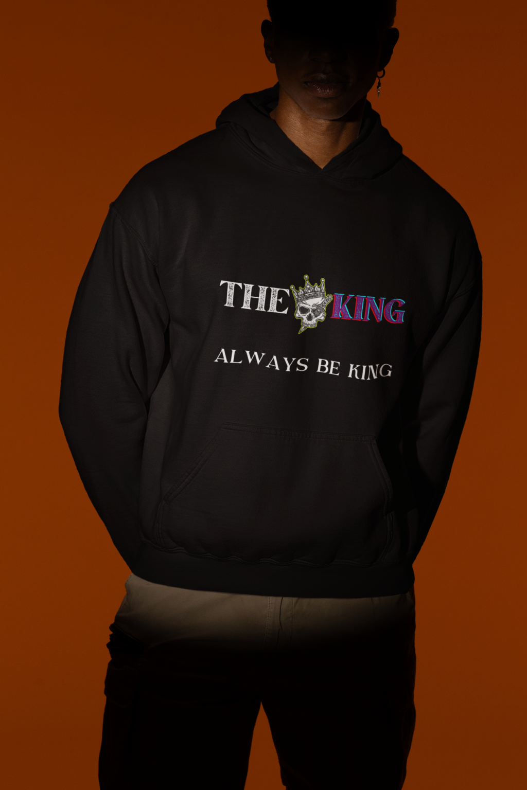 A black King Reigns Hoodie featuring a bold "THE KING" graphic with a crowned skull design and the phrase "ALWAYS BE KING" printed below. The design combines gothic and modern typography, making a powerful statement. Perfect for men who embrace confidence and leadership.