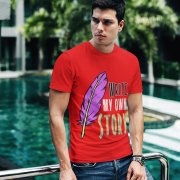 A fiery red Write Your Story Tee that embodies confidence and boldness. Featuring a colorful feather quill and the phrase "WRITE MY OWN STORY." Soft fabric by PodLyft.