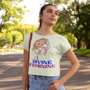 Woman styled in a neutral beige 'Divine Feminine' T-shirt, enhanced by an intricate floral line-art design. A sophisticated and earthy fashion piece, available at PodLyft.