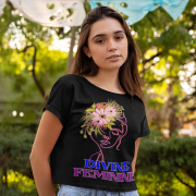 Woman wearing a sleek black 'Divine Feminine' T-shirt featuring an elegant floral line-art design. A timeless and empowering fashion statement, available at PodLyft.