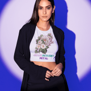 Grace in Every Petal Tee – A stylish floral crop top featuring a beautifully detailed bouquet design, worn by a confident model against a striking blue-lit backdrop. A perfect blend of elegance and modern fashion.