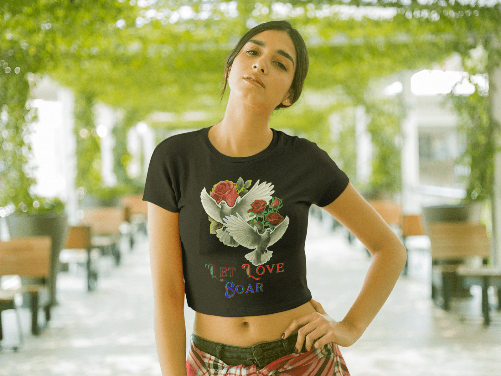 Let Love Soar Tee – Romantic Dove & Rose Design on a Black Crop Top by PodLyft. This trendy women's tee features a stunning illustration of two doves carrying red roses, symbolizing love and freedom. The 'Let Love Soar' text adds an inspiring touch, making it a perfect gift or stylish addition to any wardrobe.