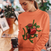 Love Heart Sweatshirt in vibrant coral, showcasing a striking red heart wrapped in green vines, roses, and a serpent. A stylish expression of love and resilience. | PodLyft