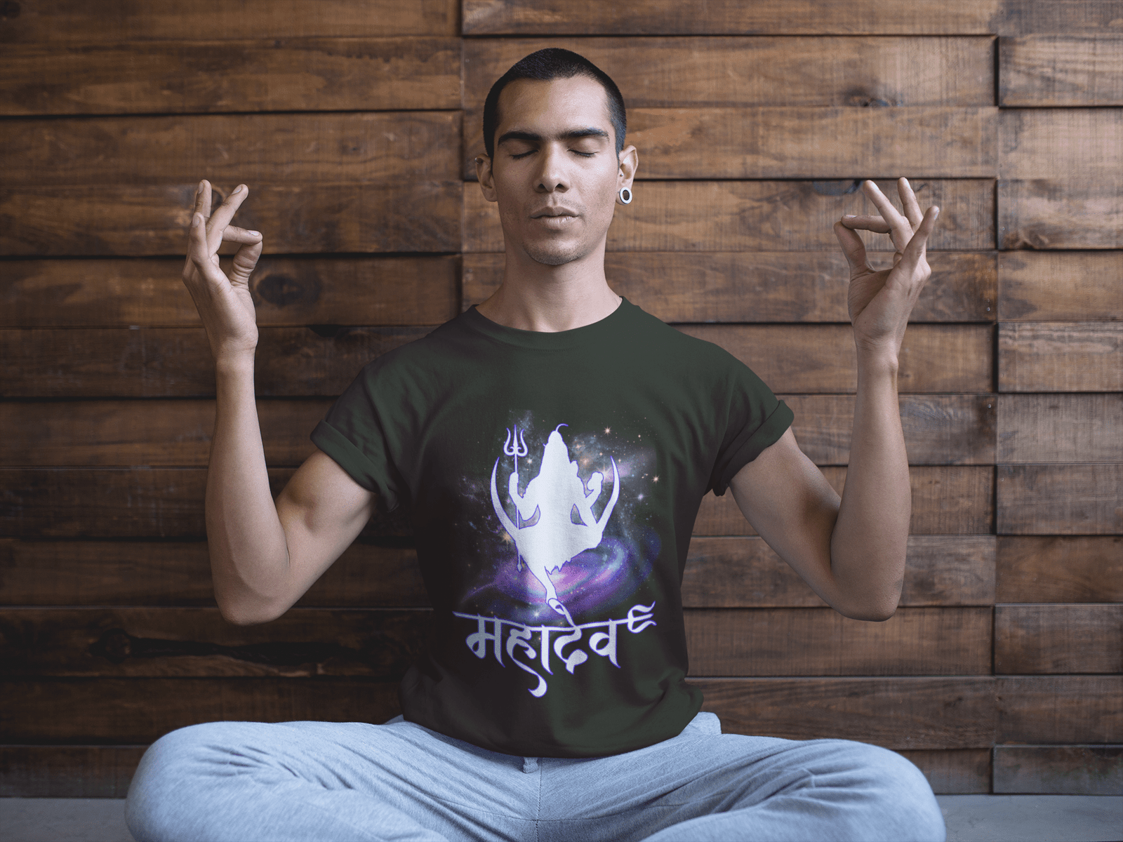 A stylish deep olive green Mahadev Cosmic Energy T-shirt featuring a cosmic Lord Shiva silhouette with "महादेव" in Hindi. Designed for yoga lovers, meditation practitioners, and devotees seeking spiritual connection. Premium cotton by PodLyft.