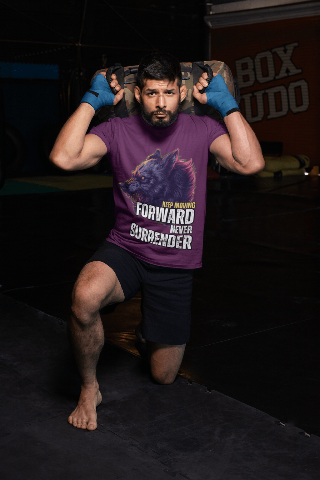 Athlete in a boxing gym wearing the Relentless Wolf Tee in purple, featuring a fierce, growling wolf graphic and bold motivational text: 'Keep Moving Forward, Never Surrender.' Capturing the spirit of resilience and determination. Available at PodLyft.