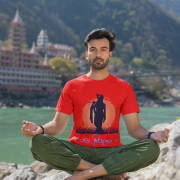 Spiritual Krishna Tee in red, featuring an elegant Lord Krishna silhouette playing the flute with a vibrant sunset background and 'जय श्रीकृष्ण' inscription, blending devotion with style.