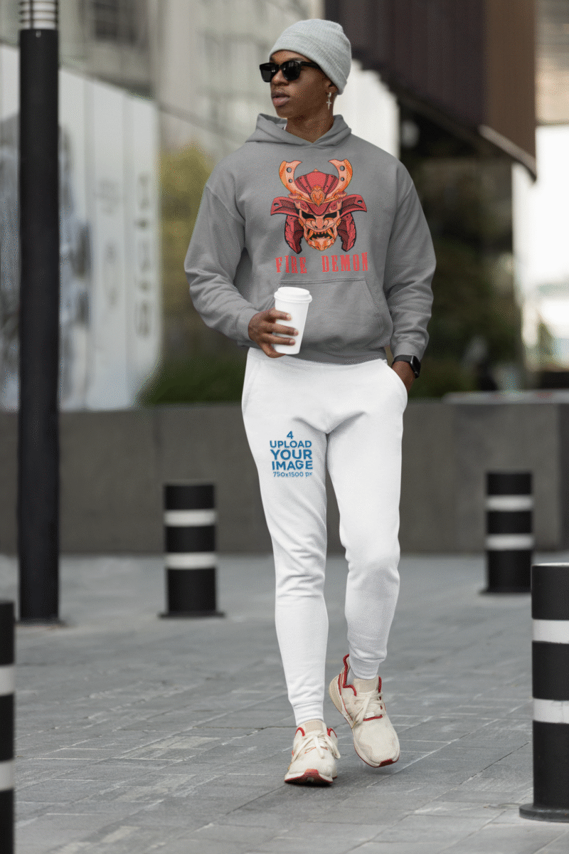 Men’s Fire Demon Samurai Hoodie by PodLyft in grey, on a mannequin, featuring a bold red and orange samurai helmet design with a demonic face and 'FIRE DEMON' text, displayed in a modern store with blurred clothing racks in the background.