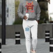 Men’s Fire Demon Samurai Hoodie by PodLyft in grey, on a mannequin, featuring a bold red and orange samurai helmet design with a demonic face and 'FIRE DEMON' text, displayed in a modern store with blurred clothing racks in the background.