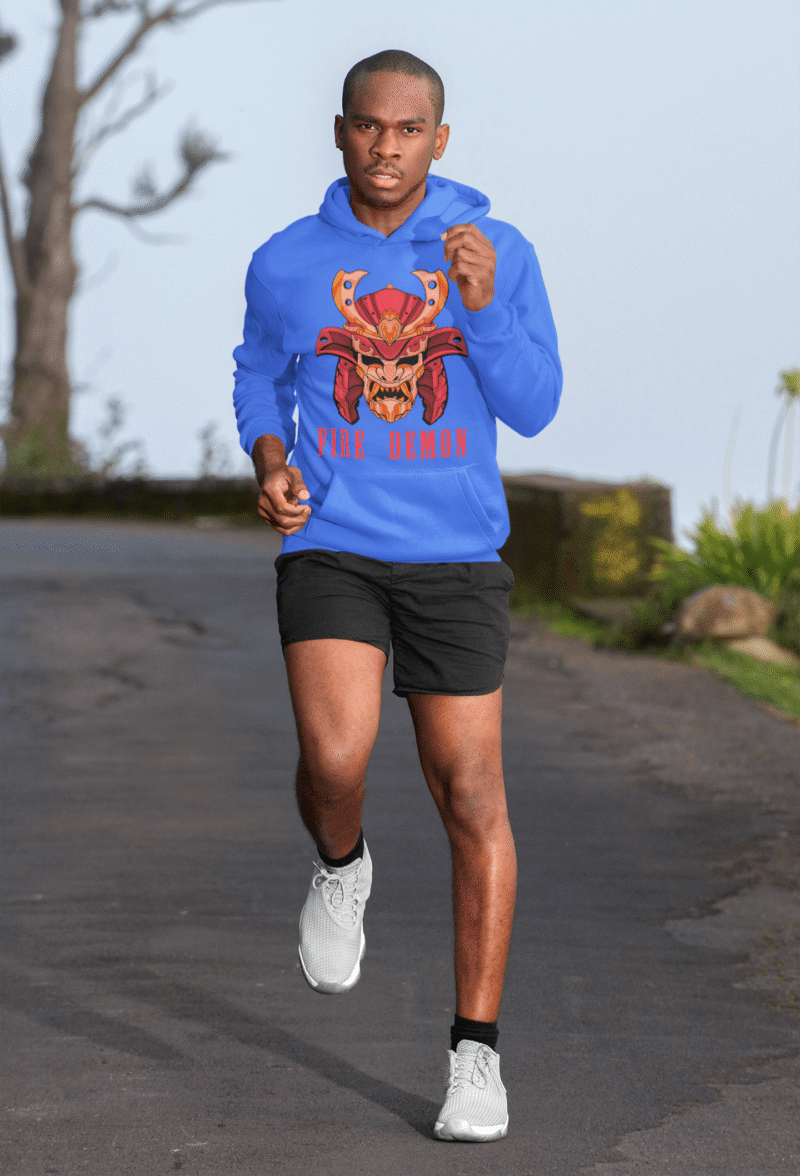 Men’s Fire Demon Samurai Hoodie by PodLyft in royal blue, on a mannequin, featuring a bold red and orange samurai helmet design with a demonic face and 'FIRE DEMON' text, displayed in a modern store with blurred clothing racks in the background.