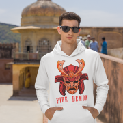 Men’s Fire Demon Samurai Hoodie by PodLyft in white, on a mannequin, featuring a bold red and orange samurai helmet design with a demonic face and 'FIRE DEMON' text, displayed in a modern store with blurred clothing racks in the background.
