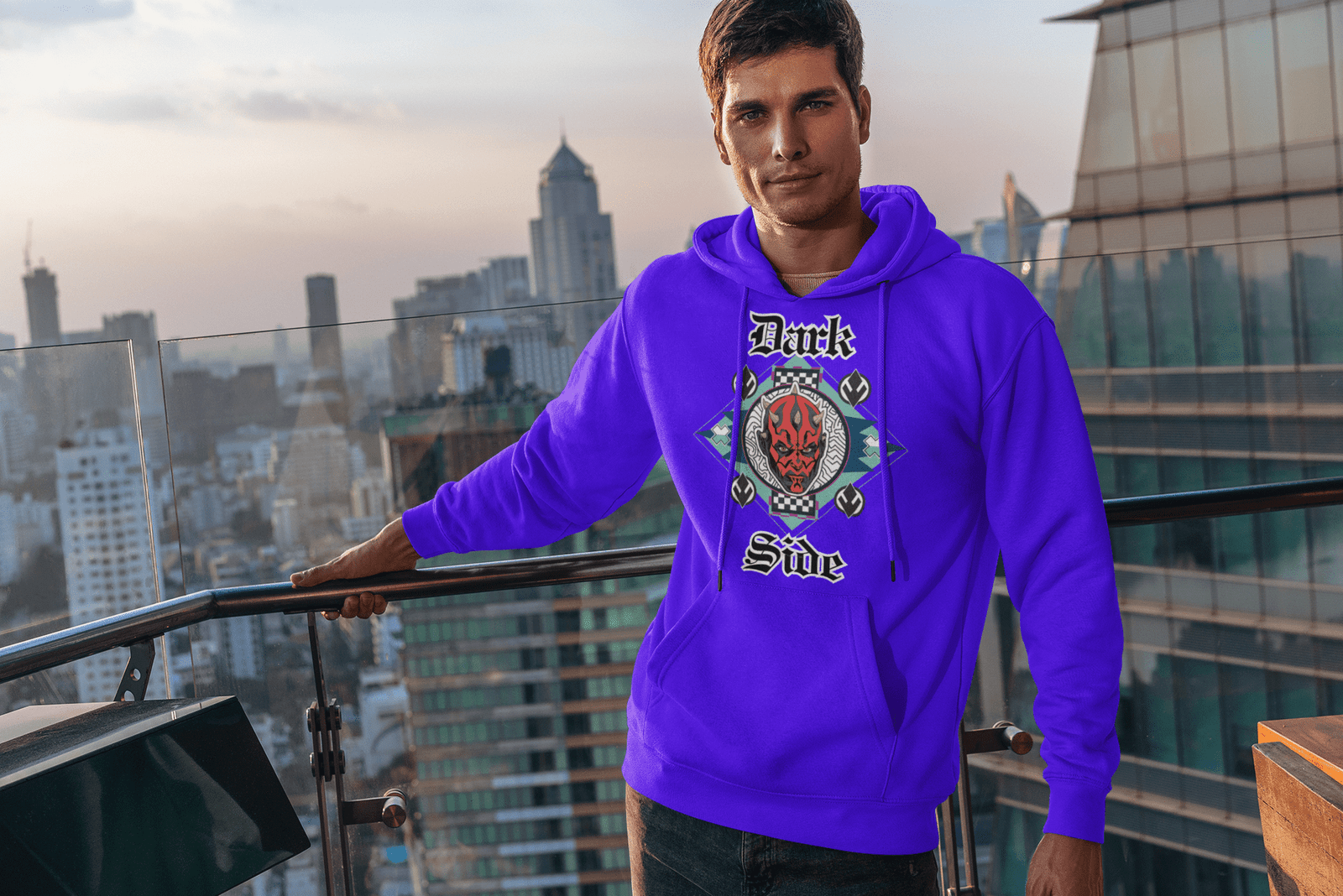 Model in a purple 'Official Darth Maul Hoodie' by PodLyft, showcasing a red-and-black Darth Maul design with yellow eyes, set in a teal and mint green diamond frame, with 'Dark' and 'Side' in gothic white text, standing on a city street with modern buildings in the background.