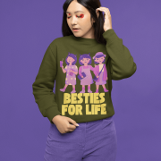 Young girl wearing an olive green sweatshirt with a colorful 'Besties For Life' graphic featuring three cartoon-style girls, set against a purple background. The design celebrates friendship in a playful and vibrant style - PodLyft's Sweatshirt for Besties