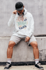 A white Men's Tough Spirit Hoodie from PodLyft, showcasing a clean streetwear design with striking, tough-inspired graphics, crafted for a trendy and comfortable look.
