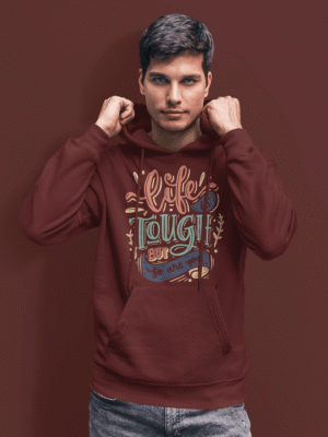 Man wearing PodLyft Men's Tough Spirit Hoodie in Deep Burgundy featuring motivational quote 'Life is Tough But So Are You' in bold, colorful retro typography – streetwear style for everyday confidence.