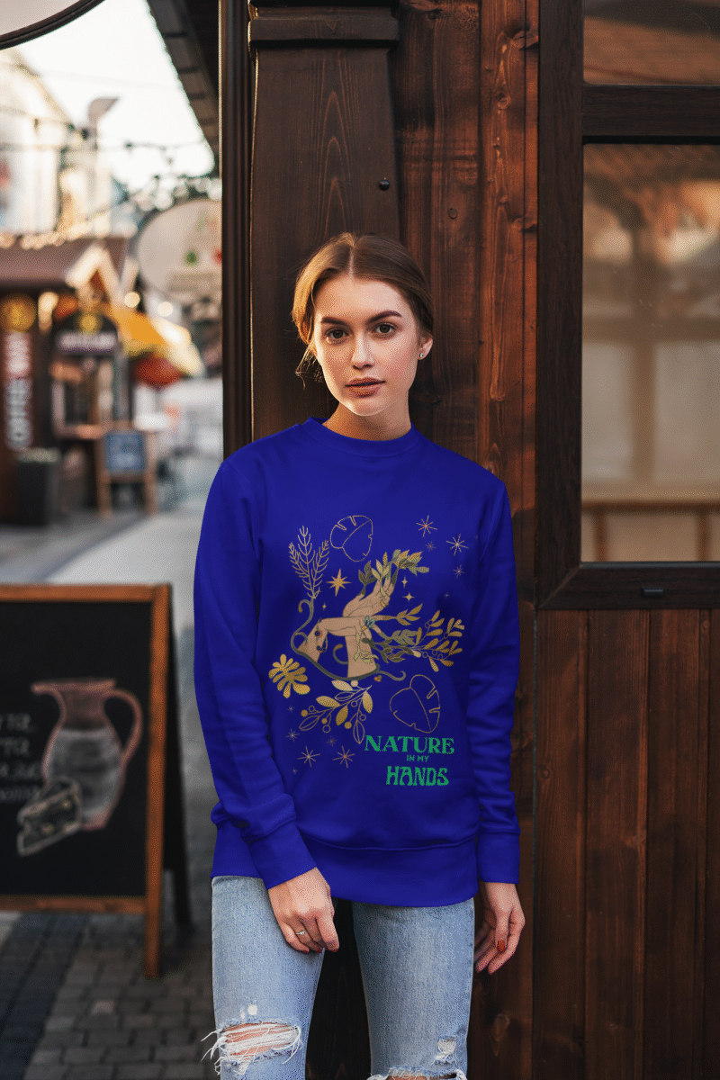 A navy blue Nature in My Hands Sweatshirt with an eco-friendly design from PodLyft, displaying a DTG-printed graphic of hands holding nature elements like leaves and flowers on the front, against a white background.