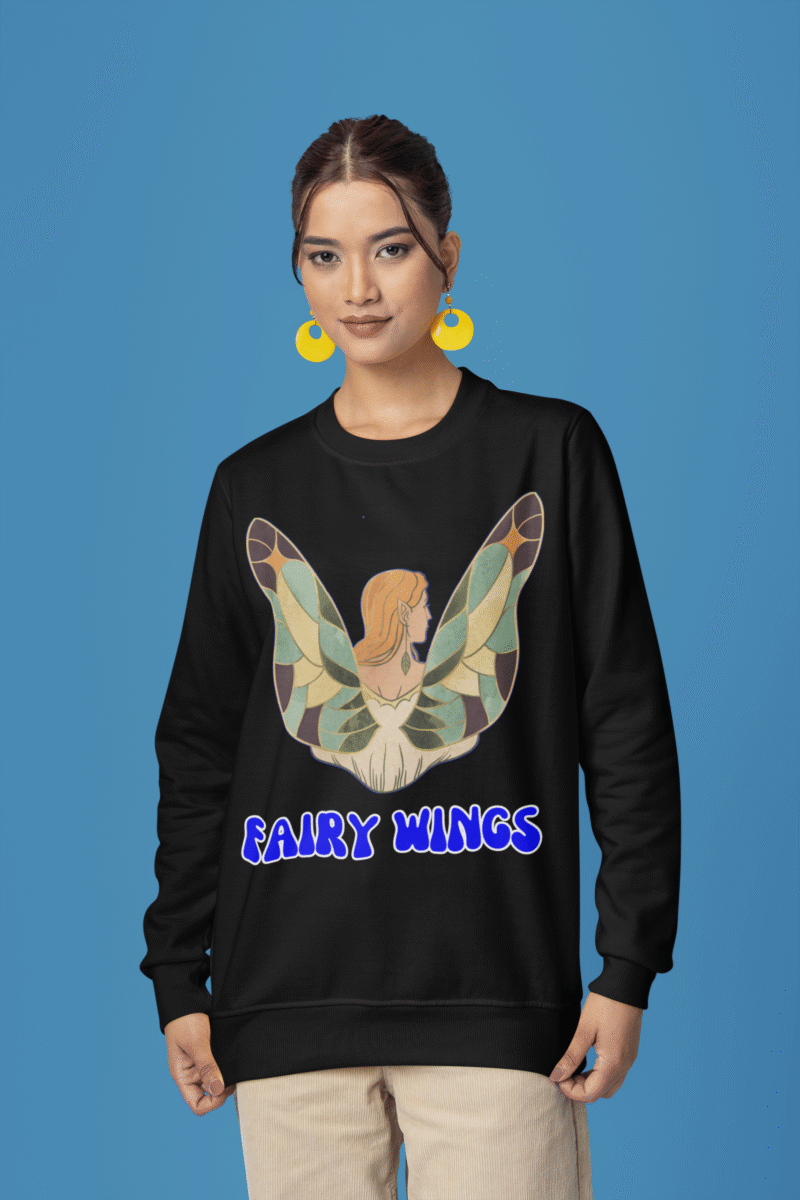 Woman wearing the Fairy Wings Hoodie from PodLyft, featuring a whimsical illustration of a fairy with colorful stained-glass-style wings and the bold blue text "Fairy Wings" on a black hoodie.